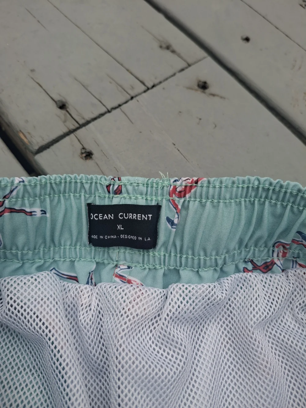 Ocean Current Mint Green Swim Trunks with Pink Flamingo Print
